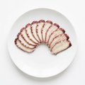Illustrativ produktbild av bläckfisk Octopus/Tako för sushitopping på vit tallrik mot vit bakgrund